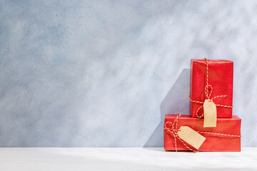 Aufkleber - Christmas template featuring gift boxes on a table with shadows and sun glares softly falling on the wall
