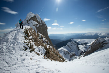 Sticker - A lone hiker gazing at a majestic, snow-covered mountain peak