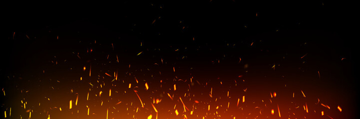 fire sparks floating upward on dark background. glowing orange embers with bright red streaks. hot b