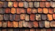 © pector - A close-up view of a textured, red clay tile roof, showing the overlapping pattern of the tiles and the weathered, aged look.