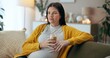 © CineLens/peopleimages.com - Coffee, relax and thinking with pregnant woman, couch and living room of home for maternity leave wellness. Break, warm drink and future mother with glass, apartment and comfort for pregnancy or rest