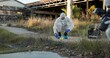 © peopleimages.com - Crime scene, people and outdoor with equipment for forensics, evidence and investigation. Team, hazmat suit or photography in field for inspection, observation and documenting proof at police markers