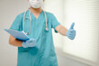 © tong2530 - Close-up hand of Doctor giving a thumbs-up, with a clean medical background, representing professionalism and positive attitude, clear and focused.