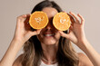 © Lomb - Young woman holding orange slices eyes healthy vitamin natural fruit wellness lifestyle fun happiness energy