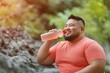 © Ryzhkov - Outdoor Fitness Plus-sized Man Enjoying a Refreshing Break on a Rocky Path