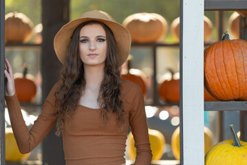 Woman wearing hat standing near the pumpkin display