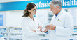 © peopleimages.com - Box, collaboration and information with people in pharmacy together for medical training. Conversation, healthcare mentor or prescription with pharmacist man and woman in clinic for retail wellness