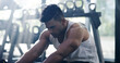 © peopleimages.com - Man, fitness and gym with break for recovery, workout or indoor training at health club. Tired, male person or athlete with rest for warm up, exercise or bodybuilding for dedication or determination