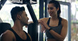 © peopleimages.com - Fitness, couple and break in gym with support, talking and bonding in healthy relationship. Happy man, woman and rest at sports equipment for wellness, team workout and progress discussion for care