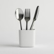 © Yevheniiya - Stainless Steel Cutlery in White Holder on Minimalist Background