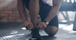 © peopleimages.com - Hands, fitness and tie shoes for workout, training or exercise start for health in gym. Sports, athlete wellness and man tying sneakers, footwear and laces to get ready for cardio and performance