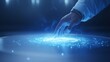 © AhmadTriwahyuutomo - A glowing hand reaches toward a luminous, swirling blue light on a surface, creating an ethereal and futuristic effect.