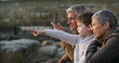 © peopleimages.com - Grandparents, grandchild and pointing on beach, outdoor and seashore for bonding together. Senior people, boy and weekend for sightseeing, ocean and vacation on winter holiday with family for support