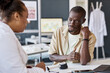© Seventyfour - Portrait of Black adult man talking to dermatologist during consultation in clinic and explaining skin rash symptoms