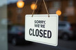 © Юлия Васильева - Sorry we are closed sign hanging in front of a shop door.