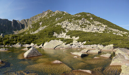 Wall Mural - Mountain lake in the mountains with clouds in the sky