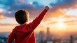 © Vee - Young Boy with Red Hoodie Raises Fist Triumphantly Against a Vibrant Sunset Skyline, Inspiring Feelings of Hope, Adventure, and Future Possibilities in Urban Environment