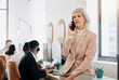 © peopleimages.com - Mature woman, phone call and talk in contact center in office with team, listen and leader with customer service. Person, crm and smartphone for tech support, job or help desk at telemarketing agency