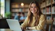 © Kromstar Studios - Young lady studying in the library with laptop