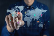 © fadfebrian - Man touching a virtual screen of world map infographic. World map infographic with color pointers.