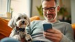 © Pinklife - A middle-aged man with glasses reclines on a comfortable couch with his dog, both focused on the smartphone, exemplifying calm domestic vibes and companionship.