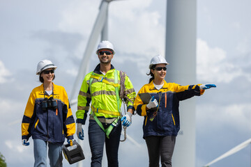 Fototapete - Engineer wearing safety uniform discussed plan about renewable energy at station energy power wind turbine. technology protect environment reduce global warming problems.