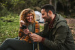 © Miljan Živković - smile couple buy online with credit card and mobile phone in the forest