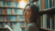 © yenart - A young woman reading in a cozy library filled with books.
