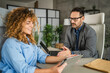 © Miljan Živković - adult man businessman work with female colleague on digital tablet