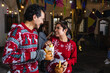© Marcos - Mexican young couple or friends having fun in posada celebration for Christmas in Mexico Latin America, hispanic people