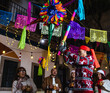 © Marcos - Mexican Posada and family breaking a traditional pinata to celebrate Christmas eve in Mexico Latin America, hispanic people and traditions