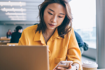 Woman using smartphone in workspace