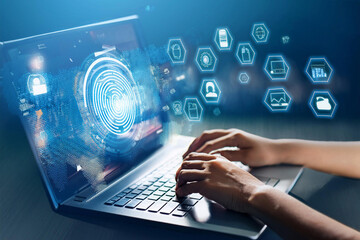 Close-up of the hands of an IT specialist working on a laptop with many virtual icons. The concept of technology and artificial intelligence development