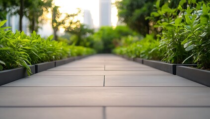 Canvas Print - A paved pathway winds through a lush green park, with tall buildings in the background.