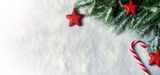 Wall Mural - Christmas background with red decorations on white snow background. Top view.