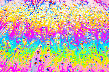 real photograph of a colorful light interference on a soap bubble surface with random swirls, curves