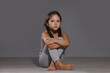 © New Africa - Orphanage concept. Sad girl sitting on floor indoors