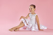 © New Africa - Portrait of little ballerina on pink background