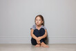 © New Africa - Orphanage concept. Sad girl sitting on floor indoors
