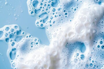 Wall Mural - foamy white skincare products on blue background.