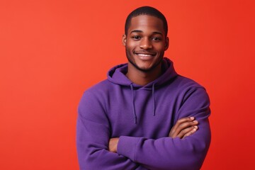 Wall Mural - A person with a purple hoodie smiling directly into the camera lens