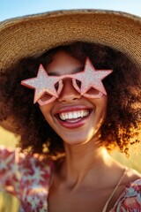 Wall Mural - A woman wearing a unique pair of star shaped sunglasses, a straw hat, and smiling at the camera