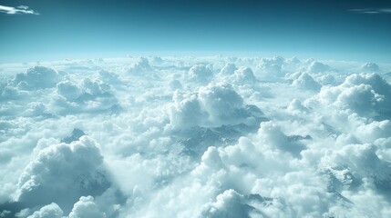 Wall Mural - Aerial view of clouds over snow-capped mountains.