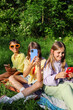 © Artem Podrez/Stocksy - Kids Enjoying Smartphones Outdoors