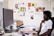 © Guille Faingold/Stocksy - Creative designer sitting at the desk of his creative studio loo
