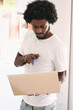 © Guille Faingold/Stocksy - Black and afro businessman checking on his laptop during his wor