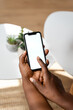 © mahalo studio/Stocksy - Close-up of man using smartphone with blank white screen