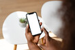 © mahalo studio/Stocksy - Person holding smartphone with blank white screen