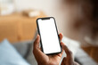 © mahalo studio/Stocksy - Unrecognizable man using smartphone with blank white screen at home