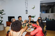 © BONNINSTUDIO/Stocksy - Happy family toasting during holiday dinner at home